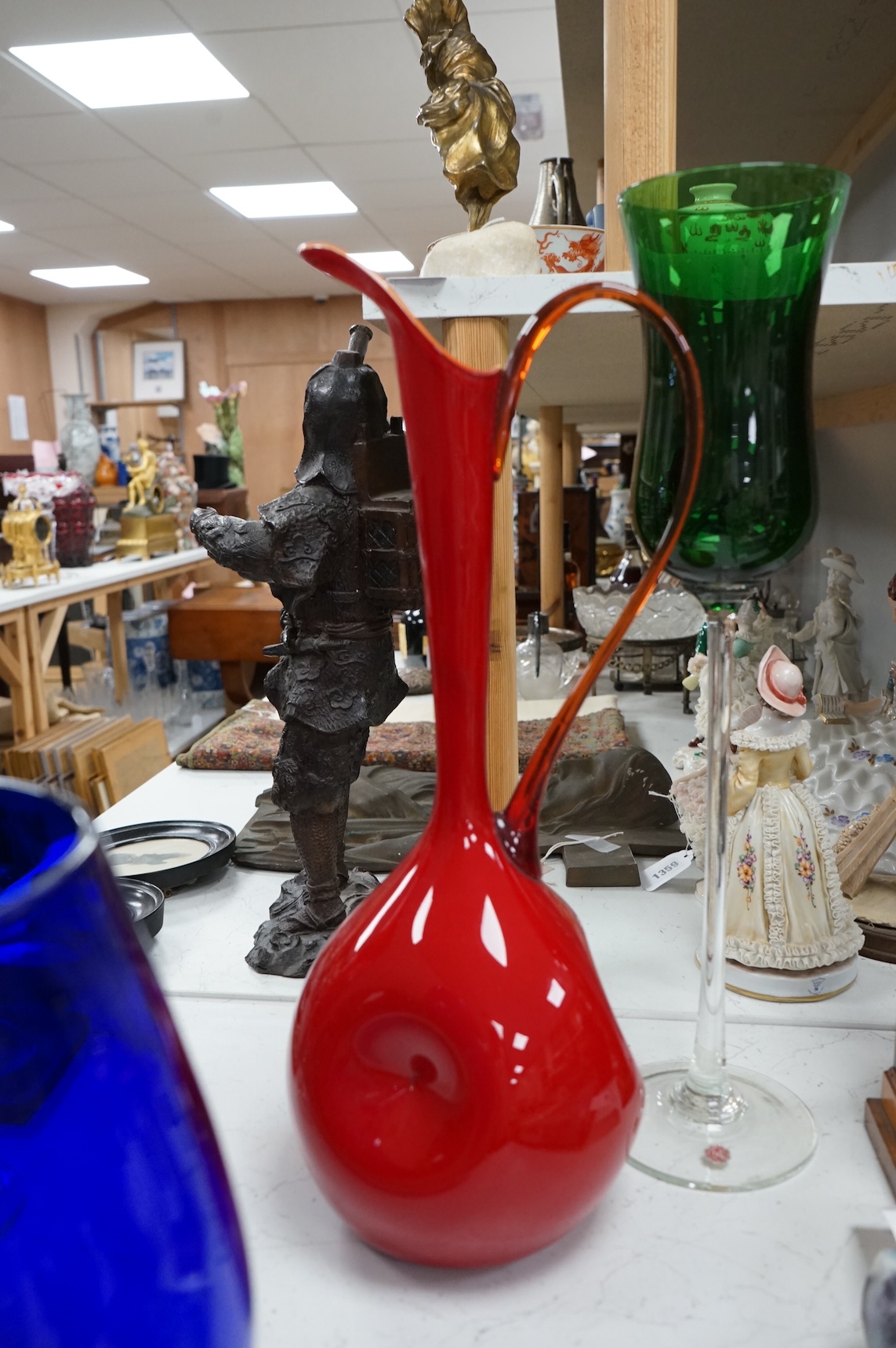Five pieces of mid-century coloured glassware, to include a jug and an oversized brandy balloon, largest 48cm high